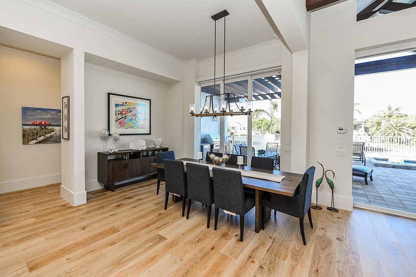 The dining area has darker furniture to accent the light home. Photo courtesy of Angela Nutter.