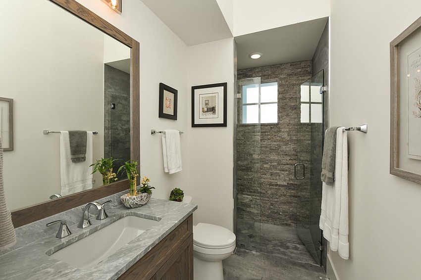 The bathroom is accented with gray tile. Photo courtesy of Angela Nutter.