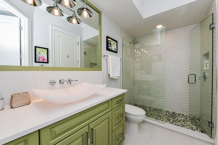 Touches of green accent this bathroom. Photo courtesy of Angela Nutter.