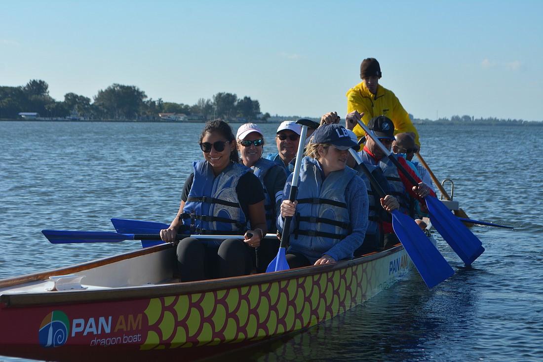 Longboat Oar Bust, a dragon boat team made up of Town of Longboat Key employees, leaves the shore with the help of their instructor during practice Saturday morning at Palma Sola Causeway Park.