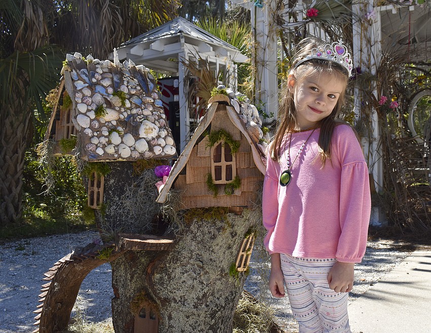 Isabel Purdy, 5, checks out one of the fairy houses.
