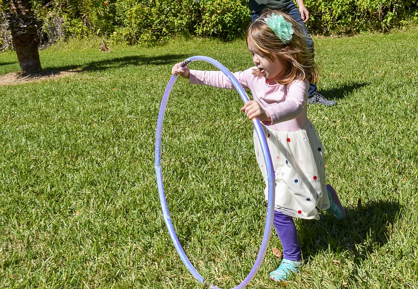 Kora Koteles, 4, prepares to jump through her hula hoop.
