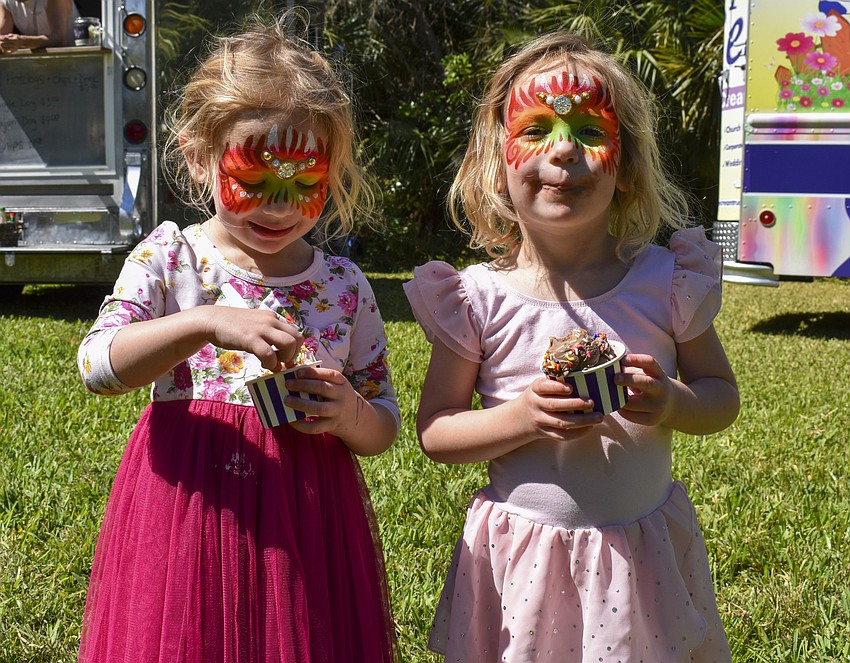 Twins Bridget and Keira Bair, 3, enjoy ice cream.