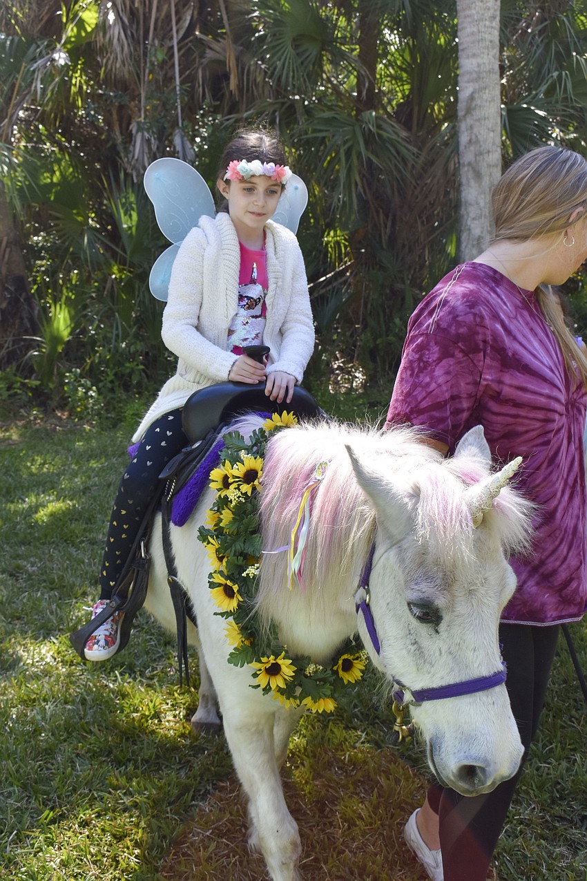 Stella Sladky, 8, rides a unicorn.