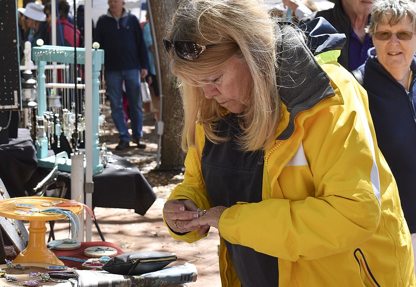 Wendy Douglas examines one of Maggie Mandell's rings.