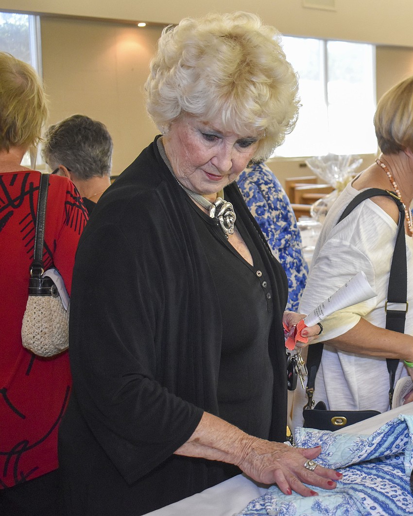 Coralie Wendt peruses the silent auction items.
