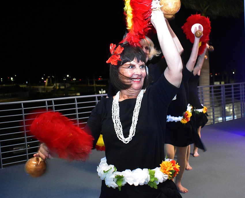 Mary Pickup performs a hula dance for the crowd.
