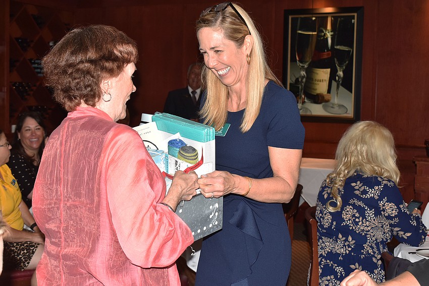 Sherri Mills presents Nancy Taussig with the raffle basket