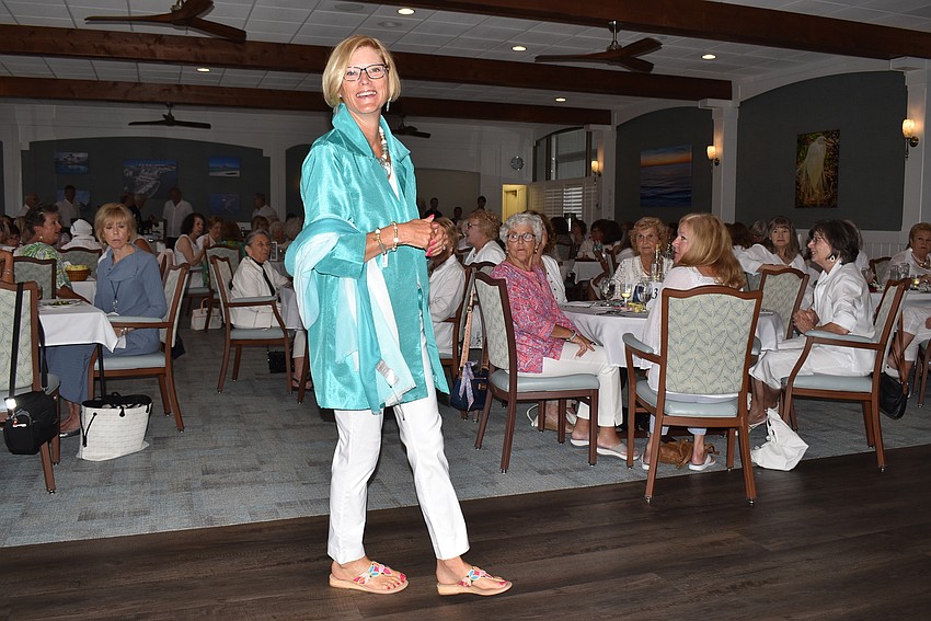 Brenda Nelson walks in blue and white.