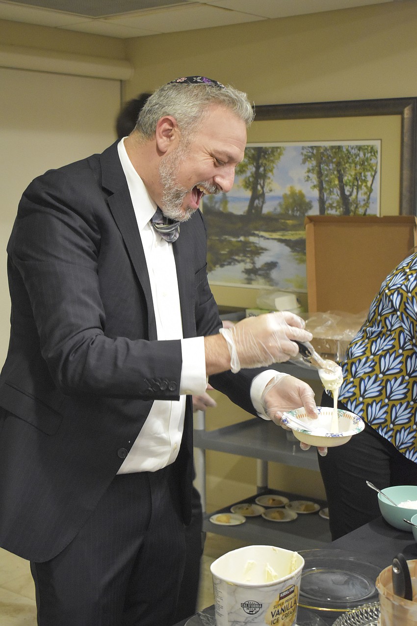 Rabbi Michael Shefrin serves ice cream to temple members.