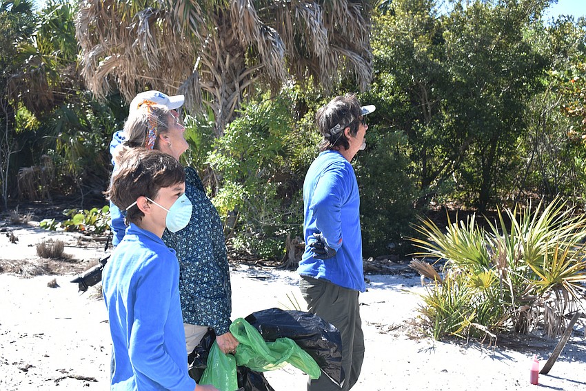 Brice Claypoole, Ronda Ryan and Benny Parrish watch an Australian pine fall.