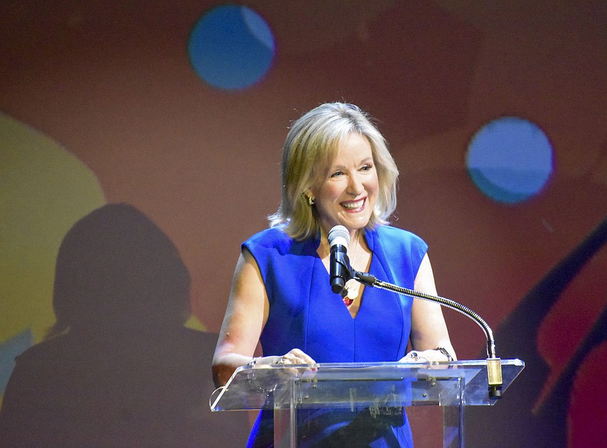 Teri Hanson welcomes the audience to the ceremony.