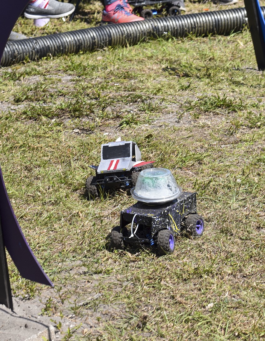 The remote control cars race through the obstacle course.