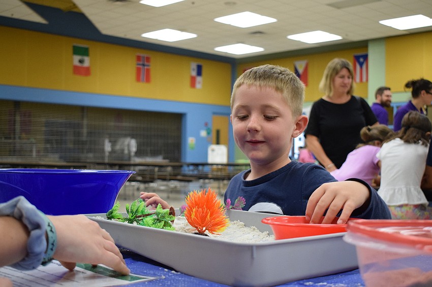Luke Zabel, who is 5, learns about weathering and erosion during a science activity.