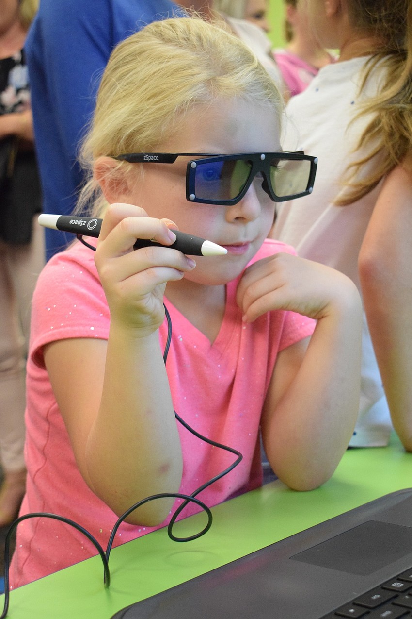 Emma Swinkels, a kindergartner, uses virtual reality to look at different aspects of the Earth.