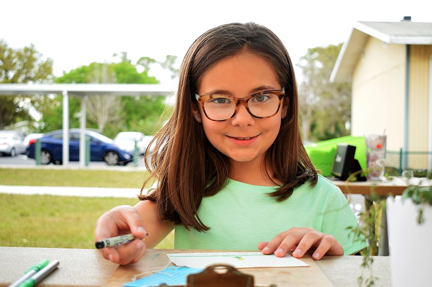 Sullivan Clark, a third grader, draws a flower. Clark enjoyed all of the activities available at STEAM night.