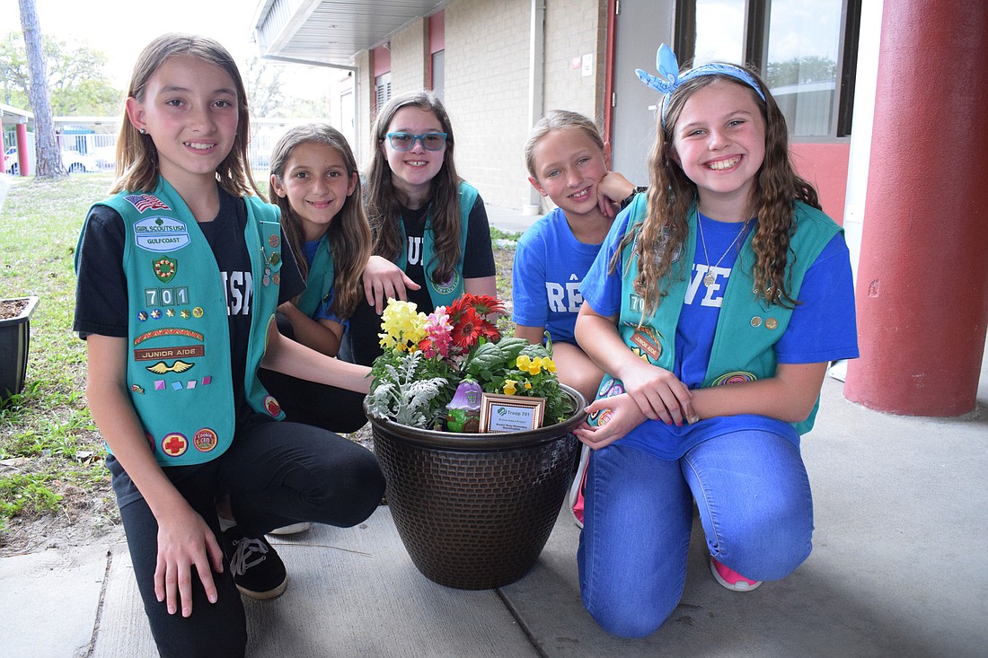 Girl Scouts Reese Gurski, Talia Giangrante, Riley Duncan, Kylee Francies and Alice Barr worked with others in their troop on a beautification project at Braden River Elementary School to earn their Bronze Award.