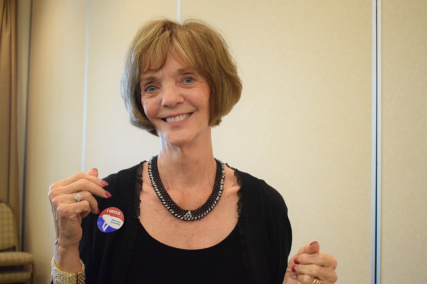 Artist Elaine Vaughn shows off one of the necklaces she made for the Creative Arts Association of Lakewood Ranch Art Show and Sale.