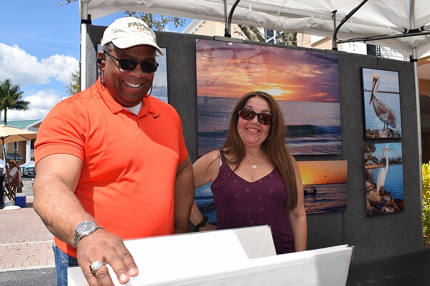 Gerald Montgomery and Martha Gonzalez, who will be moving to Lakewood Ranch in June, look through different art pieces.