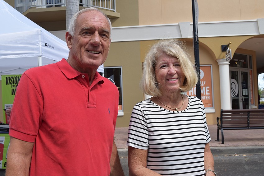 Lee and Joan Saxon walk down from their home at the Waterfront at Main Street to enjoy the different work artists have on display.