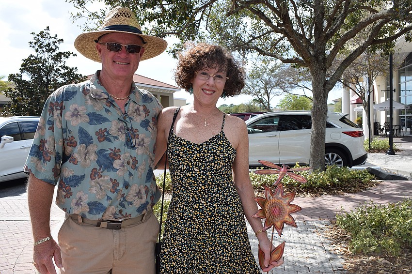 Sarasota residents Perry and Wendy Houston show off the copper garden stake they purchased at the festival. 