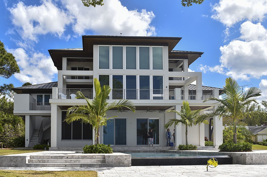 King Alexander Palms frame the infinity pool at 3725 Indian Beach Place.