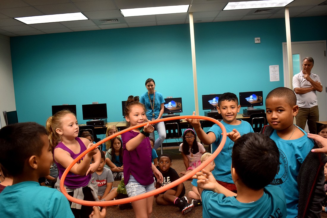 ** Ella Radovich, Sharlene Asiain-Mejia, Leonardo Moreno Martinez and Noah Saint Cyr try to lift up a hula hoop with their teammates.