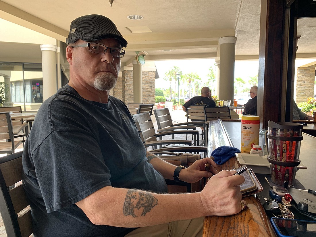 Sarasota&#39;s Brian Levasseur enjoys a drink at Linksters Tap Room before the Governor&#39;s closer of bars hit at 5 p.m. Tuesday. In the background is the hand sanitizer he brought with him.