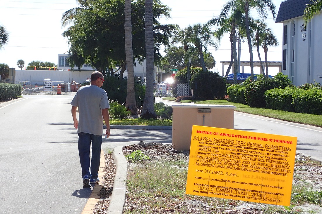 Tony Romanus walks the edge of one of Siesta Isles Association's entrances where landscape improvements wait to resume.