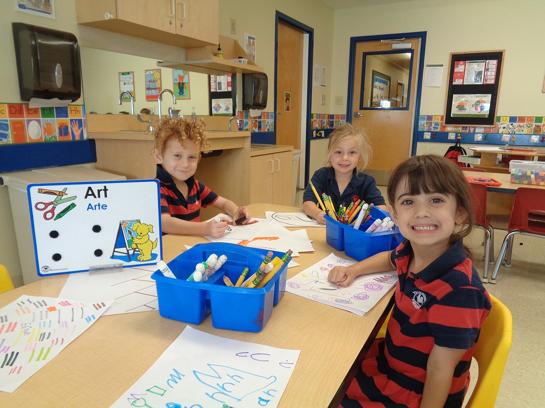 Pre-kindergartners Teddy Page, Morgan Drackett and Elise Serrano write letters and draw pictures. More children will have access to early education at the new Primrose School. Courtesy photo.