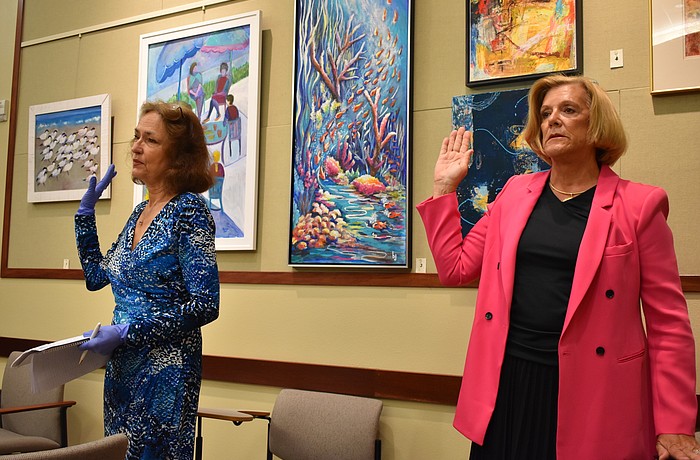 Sherry Dominick (left) and B.J. Bishop (right) are sworn in as Longboat Key town commissioners on Monday, March 23, 2020, at a statutory meeting.