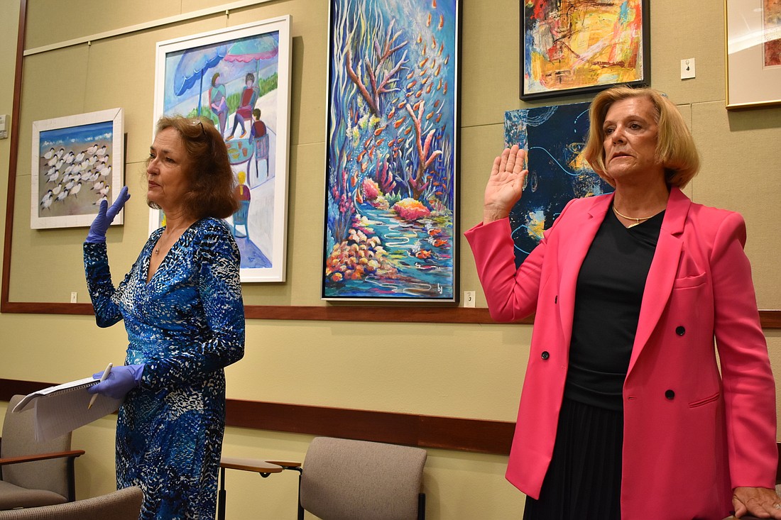 Sherry Dominick (left) and B.J. Bishop (right) are sworn in as Longboat Key town commissioners on Monday, March 23, 2020, at a statutory meeting.