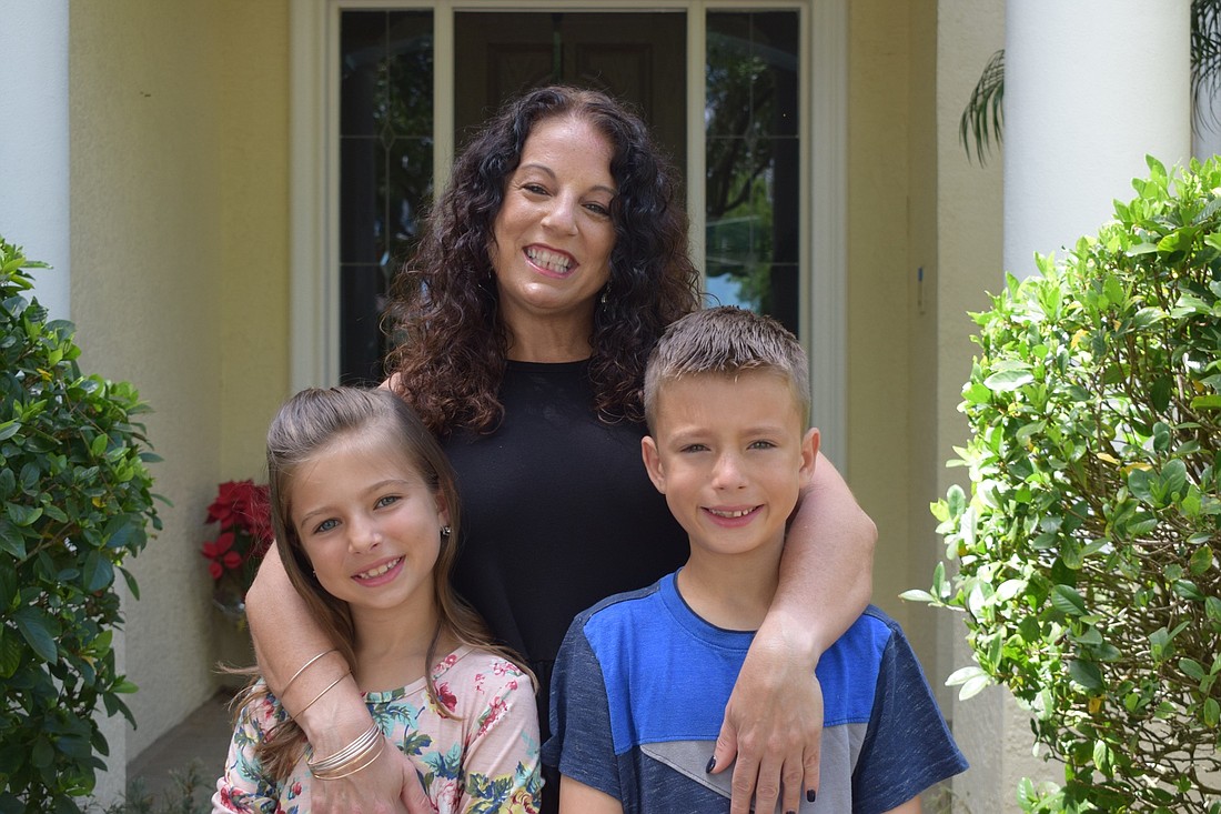 Jo-Ann Yermak (center) is worried about providing childcare for her two children, Mikenna and Hayden, who are students at Braden River Elementary School, while she works full time and they start e-learning.