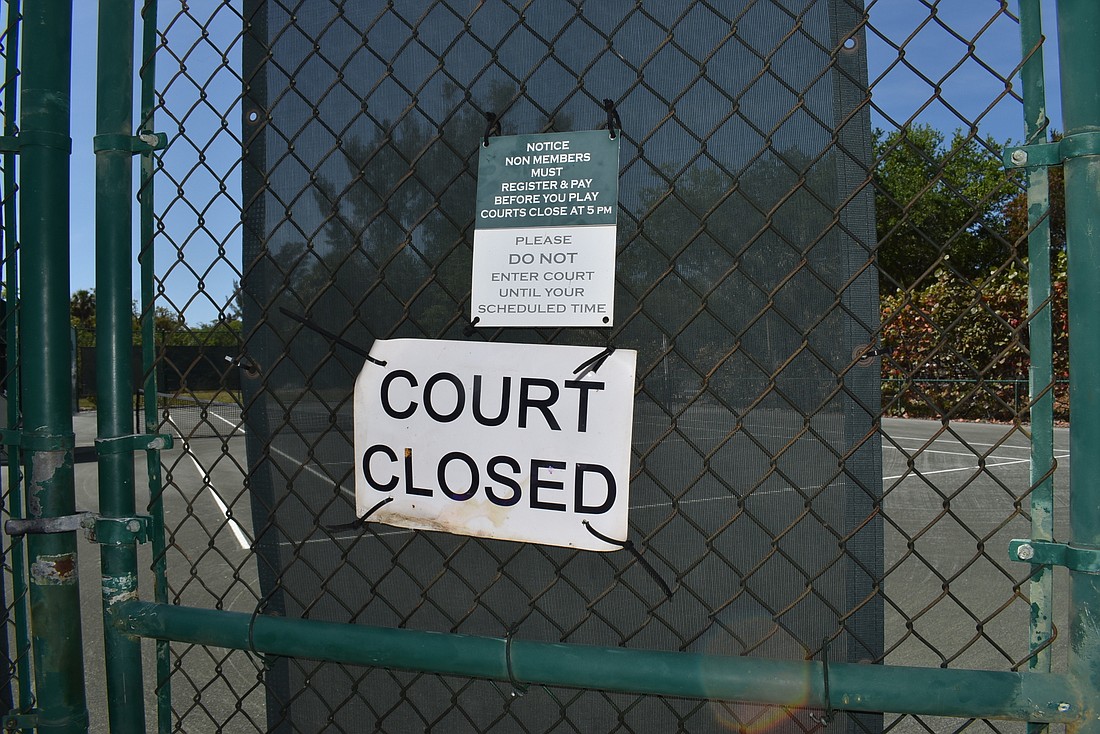 A sign indicates that the Longboat Key Tennis Center&#39;s courts are closed. The facility closed Sunday amid concerns about COVID-19.