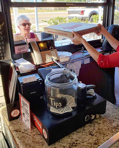 Solorzano Bros. pizza on Webber St. has closed the interior of the store and switched to a pickup window for orders, but business isn&#39;t slowing down at the restaurant. Courtesy photo.
