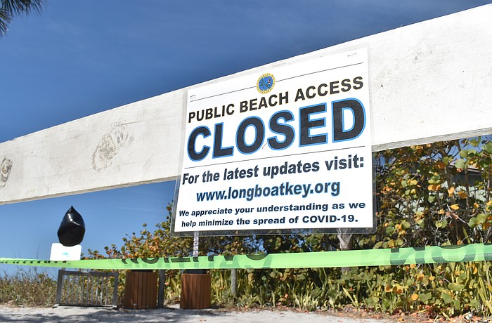 A beach access point at 2825 Gulf of Mexico Drive  is blocked and posted in Longboat Key.