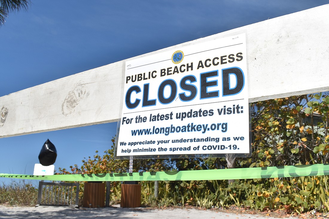 A beach access point at 2825 Gulf of Mexico Drive  is blocked and posted in Longboat Key.