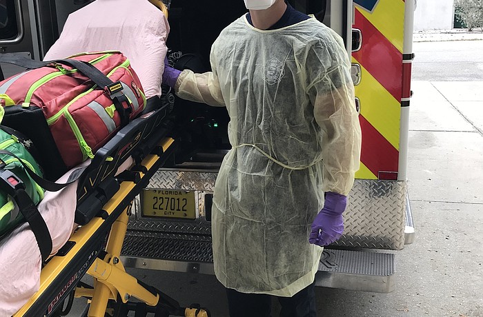 Longboat Key firefighter and paramedic David Oliger is dressed in protective gear to prevent the spread of COVID-19.