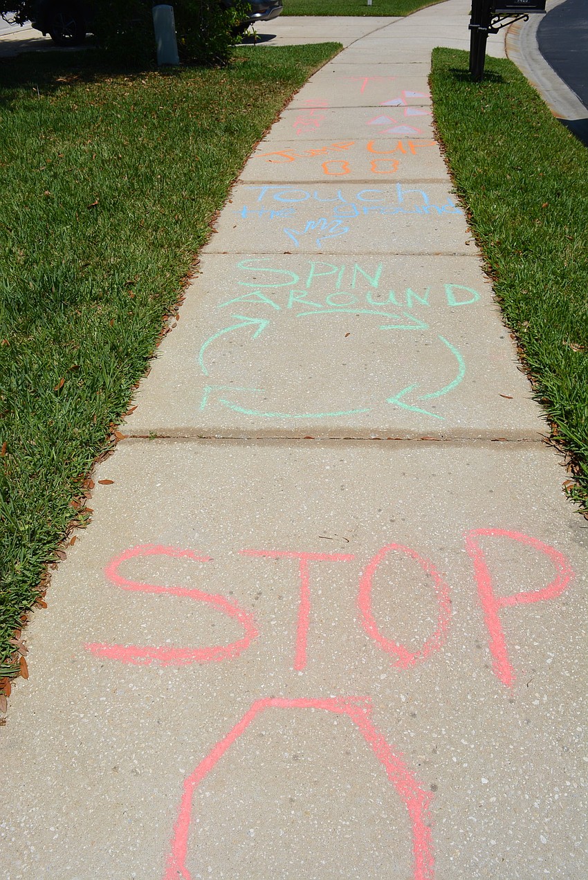 Families came up with designs and slogans. This sidewalk chalk spot even became a game for those walking the neighborhood.