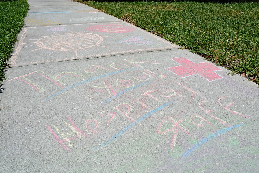 The sidewalk in front of the Miller's home paid tribute to healthcare workers and first responders with messages of gratitude.