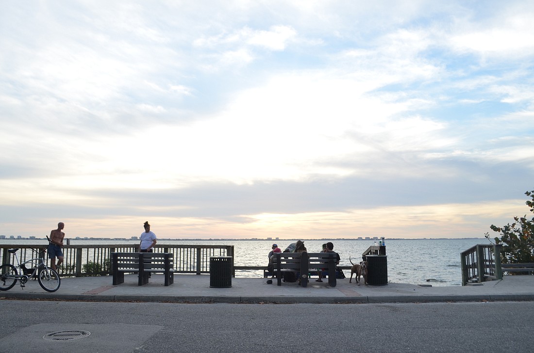 A group assembled near sunset Tuesday at Indian Beach Park. The city has prohibited social gatherings of more than 10 people, but some officials think further regulations are necessary to limit the spread of COVID-19.