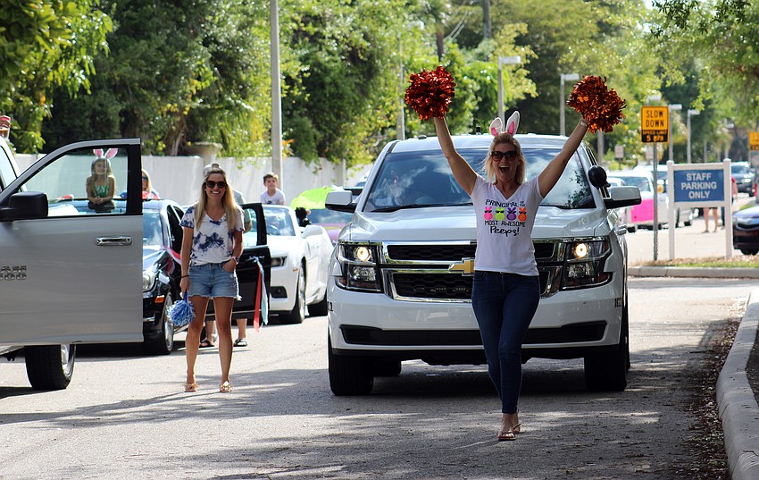 Southside principal Jennifer Nzeza cheers on teachers as they prepare for the parade
