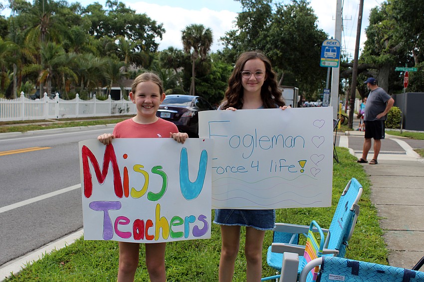 Ava and Addison Hays hold their homemade signs.