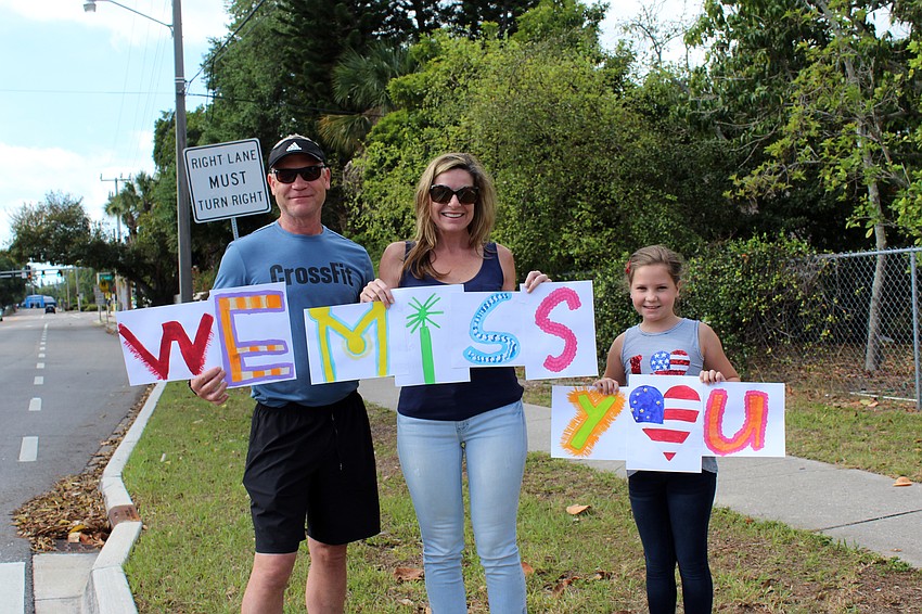 Kevin, Julie and Isabelle Cooke work together to send a message to teachers.