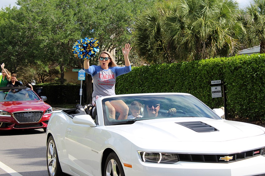 Some teachers had pompoms to cheer for the students.