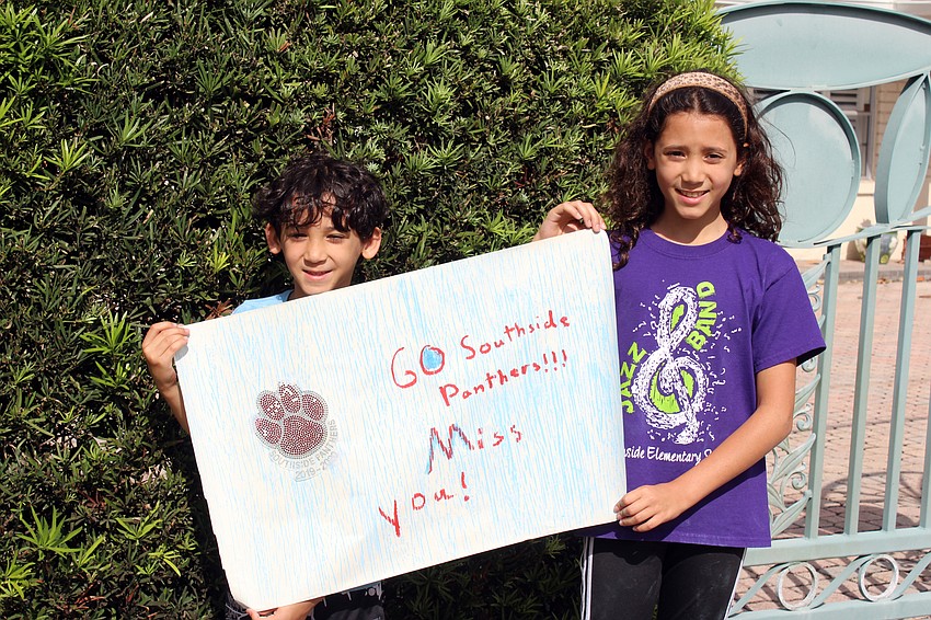 Holden and Beatrice DeGuzman show off their homemade banner.