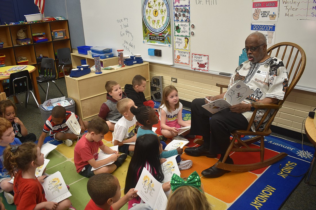 Volunteer Washington Hill reads to a kindergarten class at Fruitville Elementary.