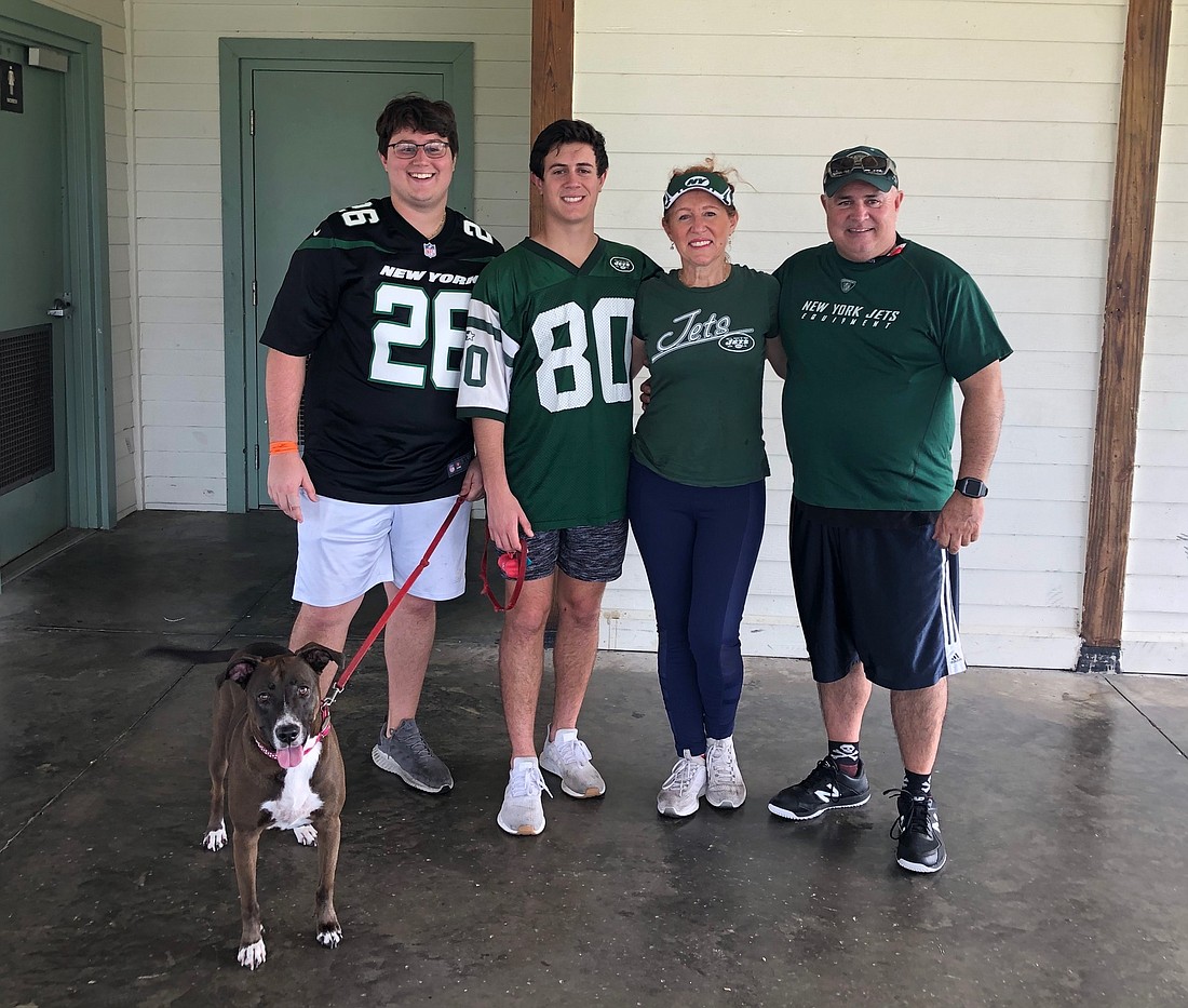 Anthony Bavaro and Mikey Bavaro and their parents, Giovanna and Louis, enjoy spending time together with their dog, Luna.