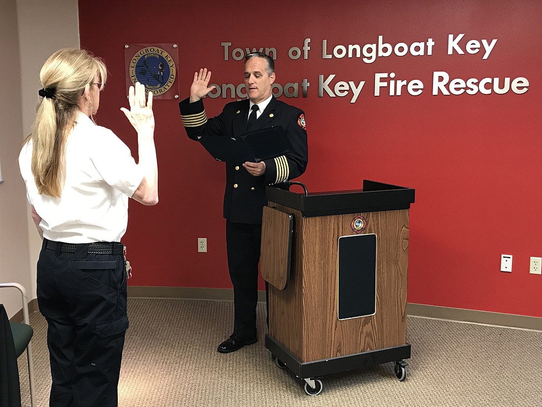 Jane Herrin is promoted from fire marshal to assistant chief of the Longboat Key Fire Rescue Department during Wednesday&#39;s "socially distant" ceremony.