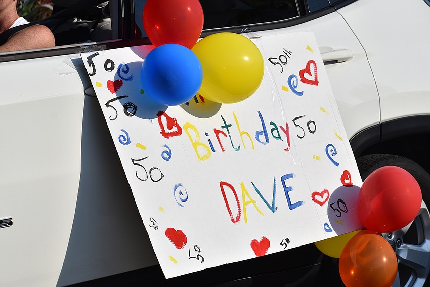 Neighbors drove by with balloons and signs.